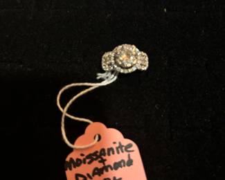 18K and Diamond Rind. Large Stone is a Moissanite. This ring has an appraisal of $5,200.00