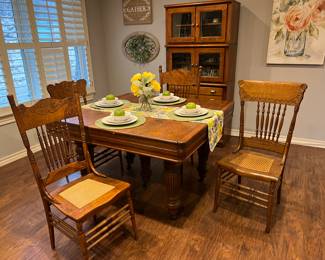 This awesome oak table extends to seat many more people. There are six chairs available and most are a little bit different from one another.