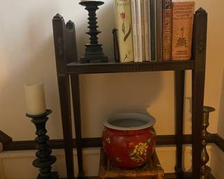 Bookcase table, vintage brass and wood candle holders, pottery and books