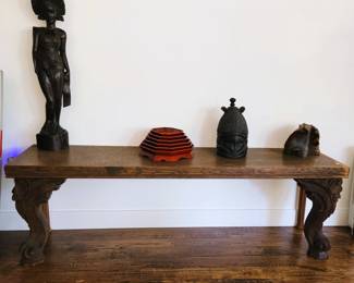 Console table made with antique wood piano legs. Carved African statue and mask