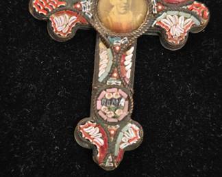 antique mosaic catholic cross with saint in middle 