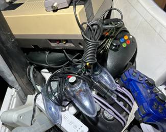 Tote filled with video game accessories. 1 NES 1 Original Xbox 1 Commadore 64 1 Wii  