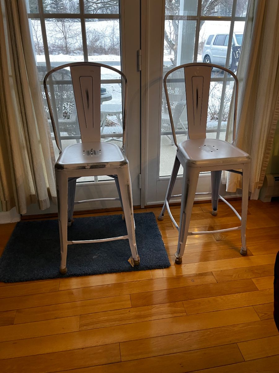 We have four of these distressed white metal stools