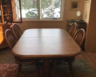 Solid oak double pedestal table with 4 chairs and pads 