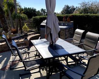 outdoor patio table with chairs and umbrella