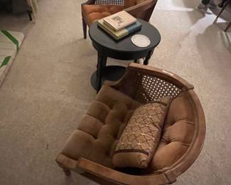 Can back chairs with a black table and books