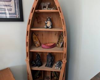 70" tall wooden canoe with paddles built on the front 