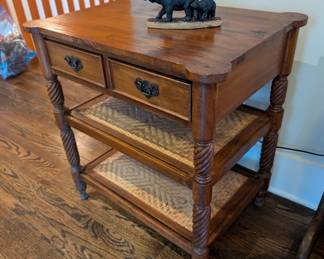 Vintage table with 2 caned shelves and 2 drawers. 
