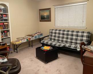 Sofa Futon Bed, Blanket Storage Table with Serving Tray, Assorted Books, CD's, DVD's, Cassette Tapes, VHS Tapes, Books on Tape, Bookcases, Antique Desk with Chair, Office Chair, Canvas on Oil