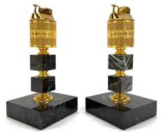 Vintage Pair Of Gold And Black Marble Tabletop Lighters: Hollywood Regency Stylr Gold-Tone Metal With Intricate Pattern Design And Black Marble Base Featuring Green Felt Bottoms.
