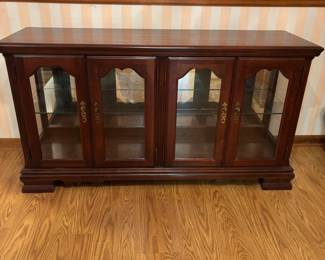 Broyhill Brown cherry wood illuminated display cabinet with glass shelves.55”w 17”d 30.5”t       $ 250.00