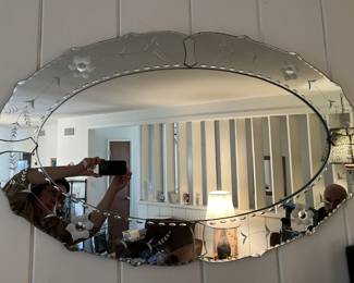 This is a photo of a very nice oval wall-mounted mirror.  You can get a sense of scale by looking at the reflection.
