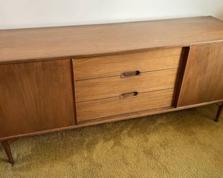 This console-style cabinet looks very stylish.  The tapered legs, the rich wood color, and the sliding front doors.  You want this, you really do.