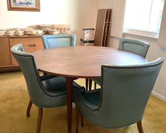 In the dining room, you can find this table and four matching chairs.  Look carefully in the back corner for three table leaves.  