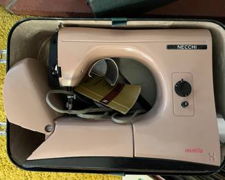 This is a Necchi portable sewing machine, model Mirella.  While an exact year may not be known, somewhere in the 1950s is likely.  