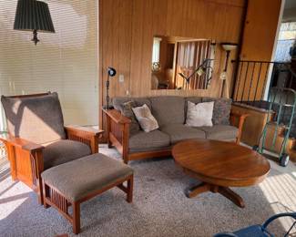 Still in the same room is a small sofa and matching chair with ottoman (or footstool).