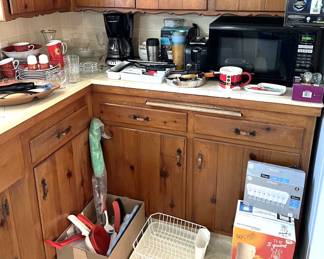 Here in the kitchen, a microwave, a dish drain, a coffee maker, and lots more appliances and utensils.