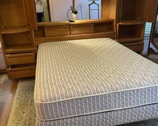 Queen Size bed and Mirrored Headboard Wall unit.  Four drawers; four shelves; sliding doors for storage coverage, shelf.