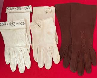 Vintage gloves.  The white gloves are leather. Brown are suede.