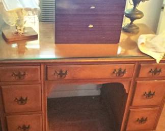 Maple desk.  Sewing cabinet, lamp and decorative Bible stand on top.