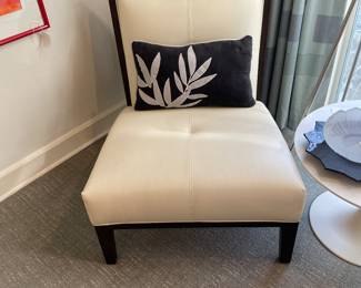One of two white leather chairs