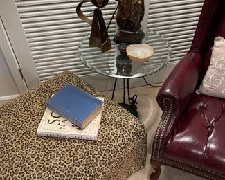 Leopard ottoman and glass top bronze finished cocktail table