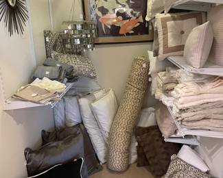 View of linen closet with decorative pillows ,sheets and accessories 