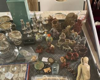 Wonderful collection of small oriental soapstone carvings , jade and ivory and sterling Salt and peppers 