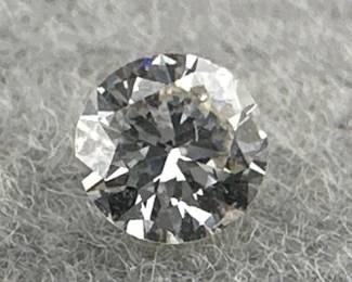 Loose, round cut diamond is 0.25 carats, G color, VS2 clarity