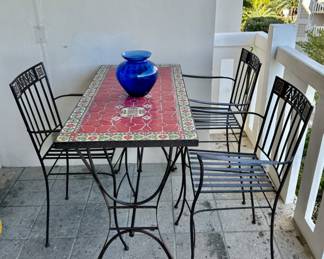 The table and blue vase are sold. The chairs are available for purchase.