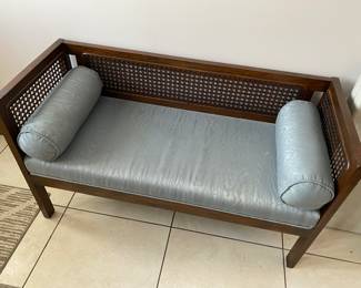 Caned back and sides wood bench with cushioned seat