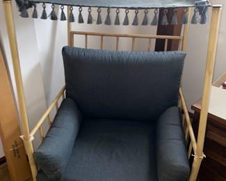 Oversized cushioned arm chair with canopy