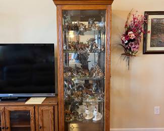 Nice smaller size oak curio cabinet with sliding door. Lighted, mirrored back. There are a pair of these.
Contents for sale as well.
Please note- TV is not for sale.