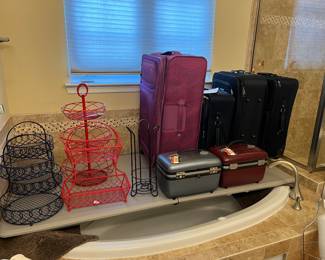 Metal tiered baskets, suitcases