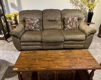 Neutral fabric sofa. I believe it’s a recliner.