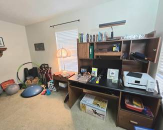 Exercise equipment, office desk, copier/printer, ceiling fan NIB (new, in box), a nightstand, tall lamp and a few books