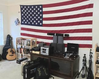 US Flag (4.8' x 9.3') by Valley Forge Flag Company, TV stand with storage, stereo + speakers, slide projector, 2 guitars, tripods, camera cases, CDs & DVDs