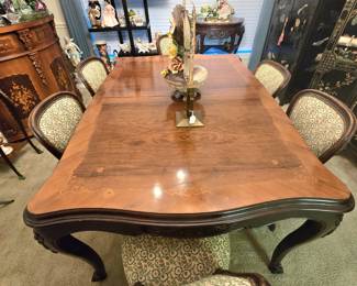 Antique dining table with 6 upholstered chairs, and a room full of furnishings and collectibles