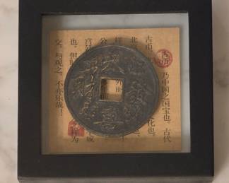 Oriental framed coin