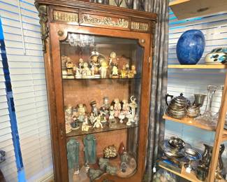 Antique curio filled with collectible figurines