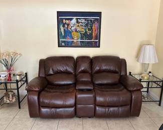 One side is a rocker-recliner.  Storage compartment in center w/cup holders