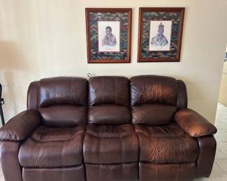 Leather, power reclining.  Worn areas can be re-dyed.  I have a great company that can do that right in your home.