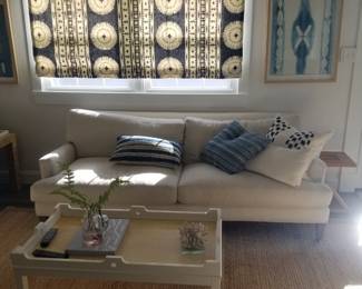 Stylish sofa; artwork; window treatments