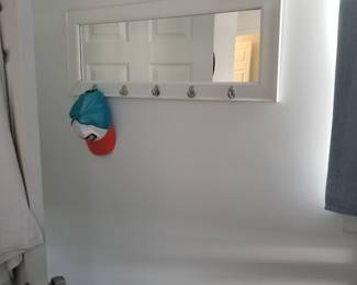 Wall mirror with hooks