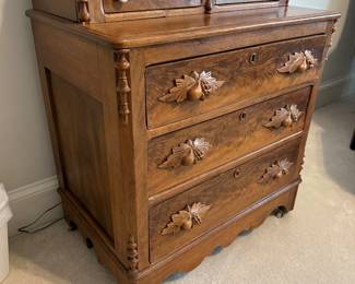 Antique Victorian step back chest with glove boxes and carved leafy pulls on casters