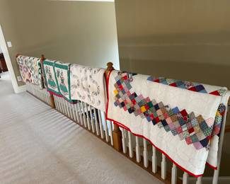 Numerous vintage hand made quilts
