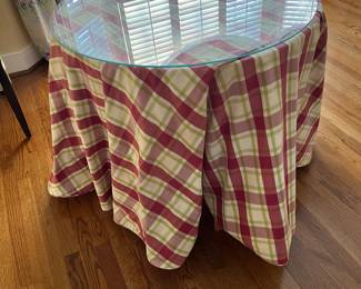 Round accent table with glass top and heavy tablecloth cover