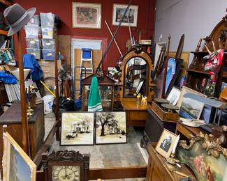 IT'S A LITTLE BIT MESSY AT THE REAR OF OUR STORE BUT I WILL DESCRIBE: The mirror directly off-center at rear is part of the Eastlake bedroom set with a hand carved Rams Head. Just to the right is a mirrored headboard with shelves. On far left at the foot of the bed frame is the matching dresser with marble top. There are end tables to this set, also with marble tops. The bed frame shown is not part of the set but is in the same rich walnut wood. This Eastlake bedroom set was owned originally by #DAWN WELLS #MARYANNE # GILLIGAN'S ISLAND. Whom we had the sincere pleasure of doing an estate sale for: RIP DAWN.  Strewn about are misc. 70's art, an antique wall clock, Edaudian gold gilded buffet header, misc. art & more...