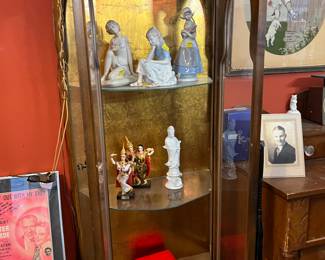 This 1950's walnut cabinet with gold backing is very unique. The arched glass and "half-octagon" shape give it a Medieval kind of look... All shelves are glass helping the transferrance of light throughout. 