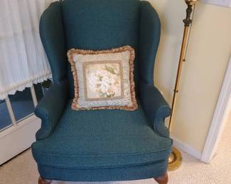 Blue Wingback Chair with Pillow and Lamp